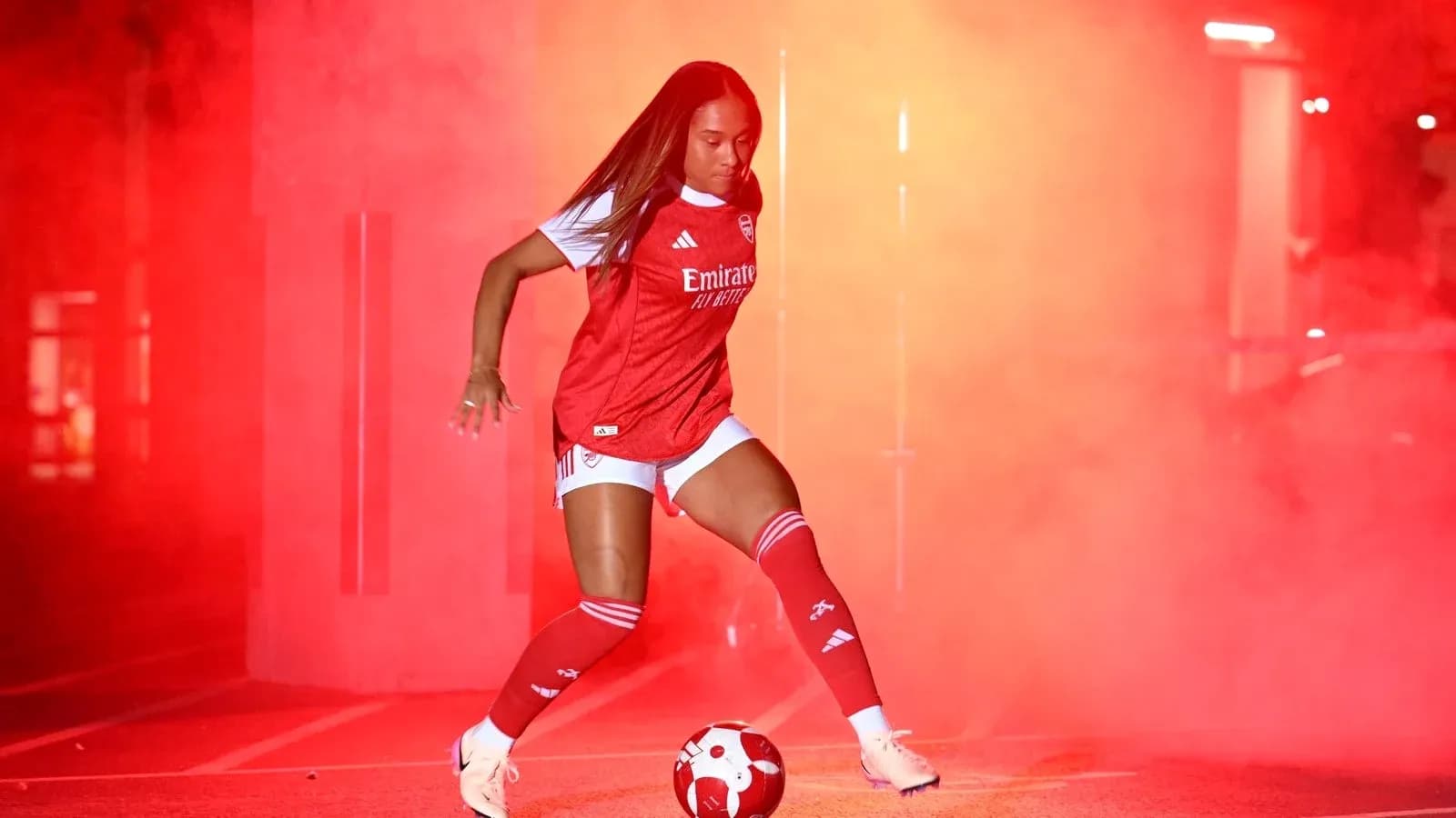 Player in Arsenal kit with soccer ball in fog Player in Arsenal kit with soccer ball in fog