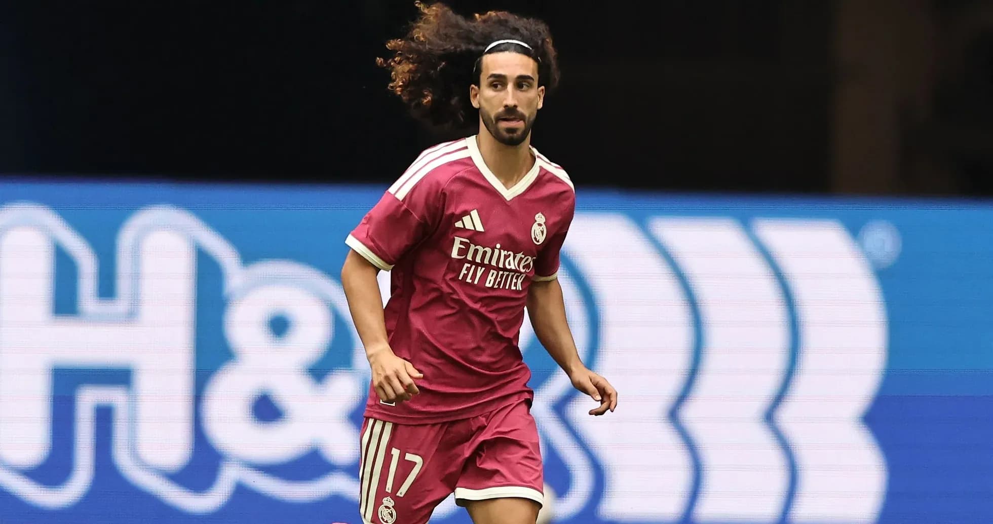 Player running in pink Real Madrid jersey on field Player running in pink Real Madrid jersey on field