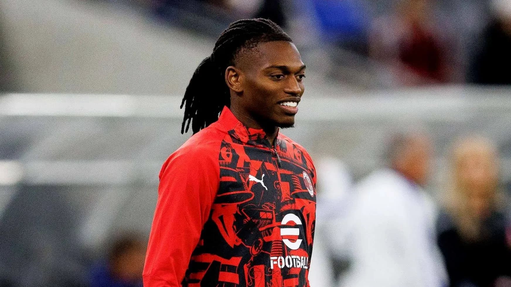 Player in red training gear smiling before match Player in red training gear smiling before match