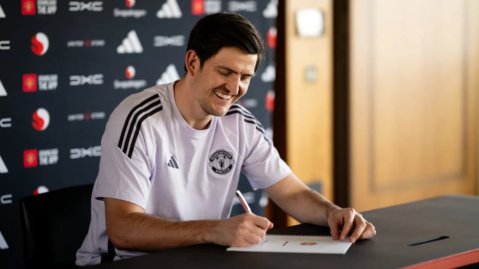 Player signing contract at press conference table Player signing contract at press conference table