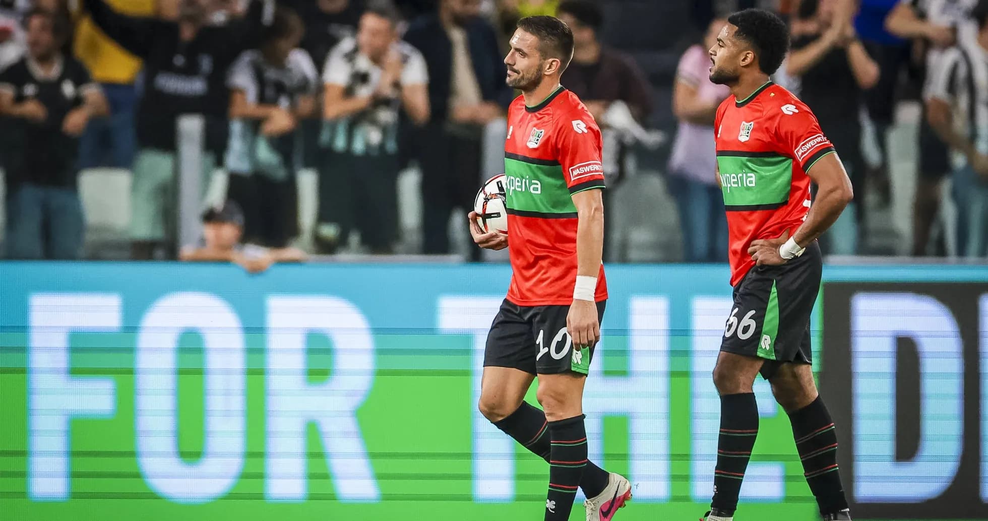 Two players walking off the pitch after match Two players walking off the pitch after match