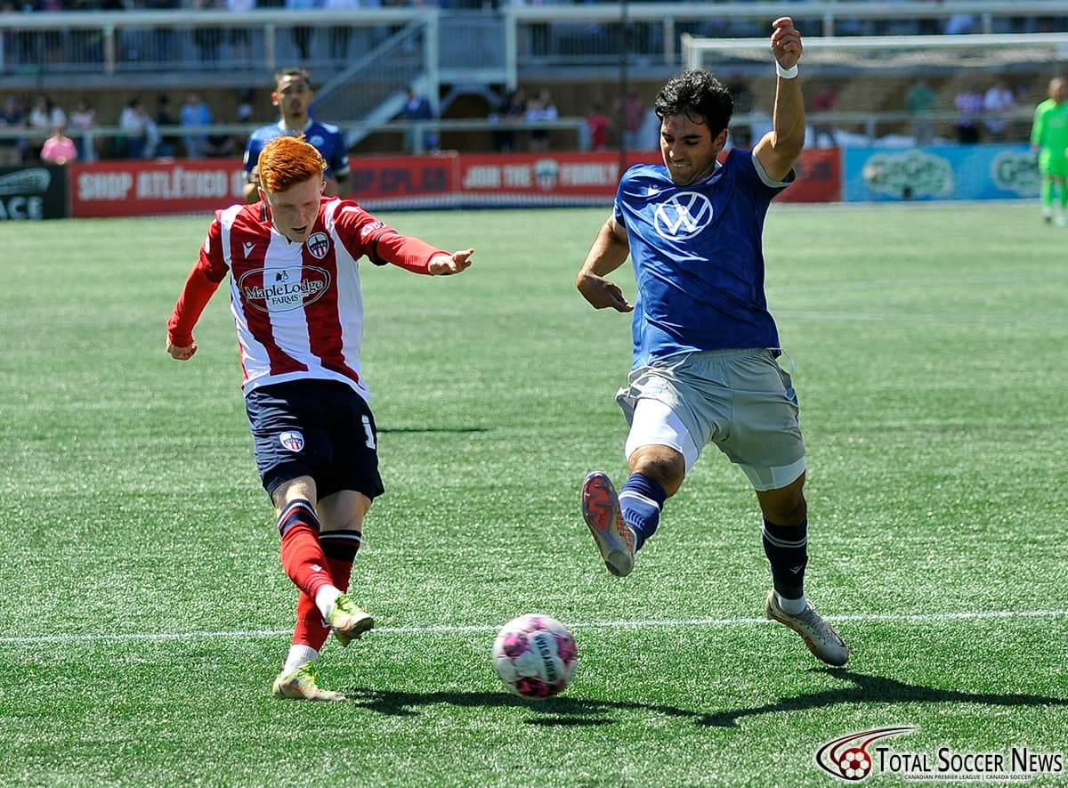 Players competing for the ball in football match Players competing for the ball in football match