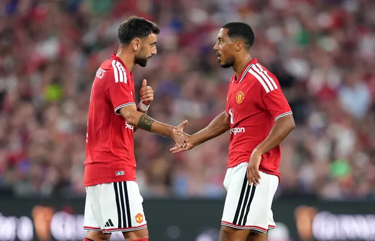 Two Manchester United players discussing on the field Two Manchester United players discussing on the field