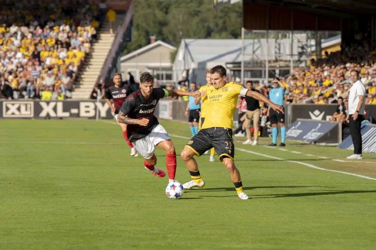 Players competing for the ball in UEFA match Players competing for the ball in UEFA match