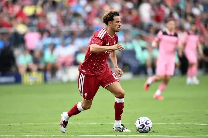 Player in red kit dribbling the ball during match Player in red kit dribbling the ball during match