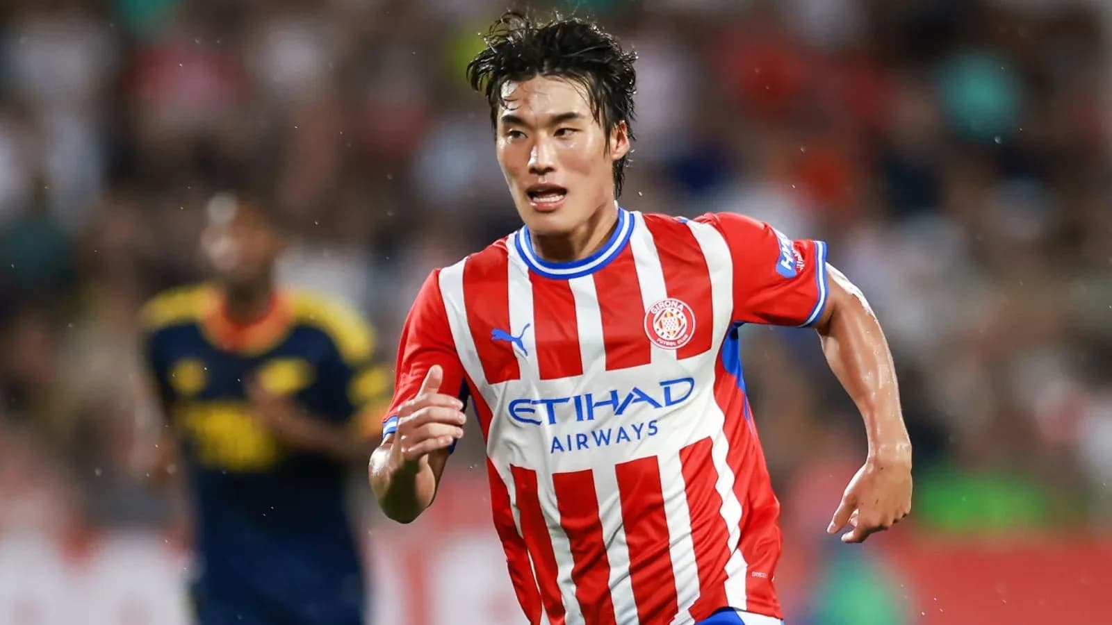 Player running during a football match for Girona Player running during a football match for Girona