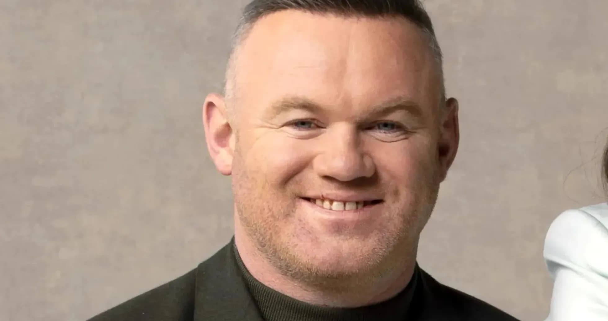 Man smiling in a black jacket with a neutral background Man smiling in a black jacket with a neutral background