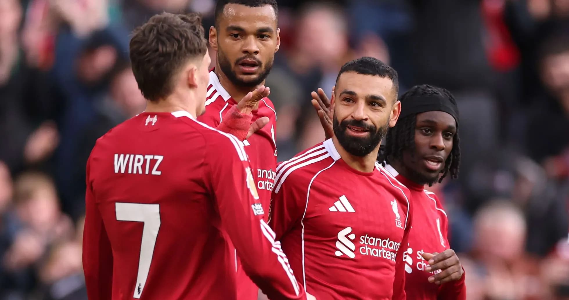 Liverpool players celebrating during a match Liverpool players celebrating during a match
