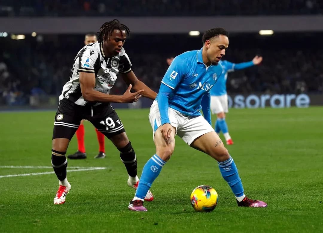 Napoli player challenged by Udinese opponent Napoli player challenged by Udinese opponent