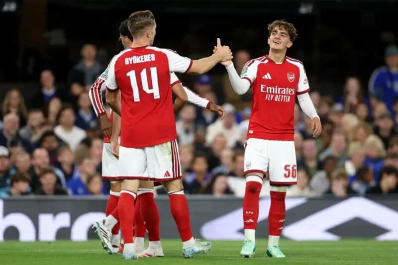 Arsenal players celebrating during a match Arsenal players celebrating during a match
