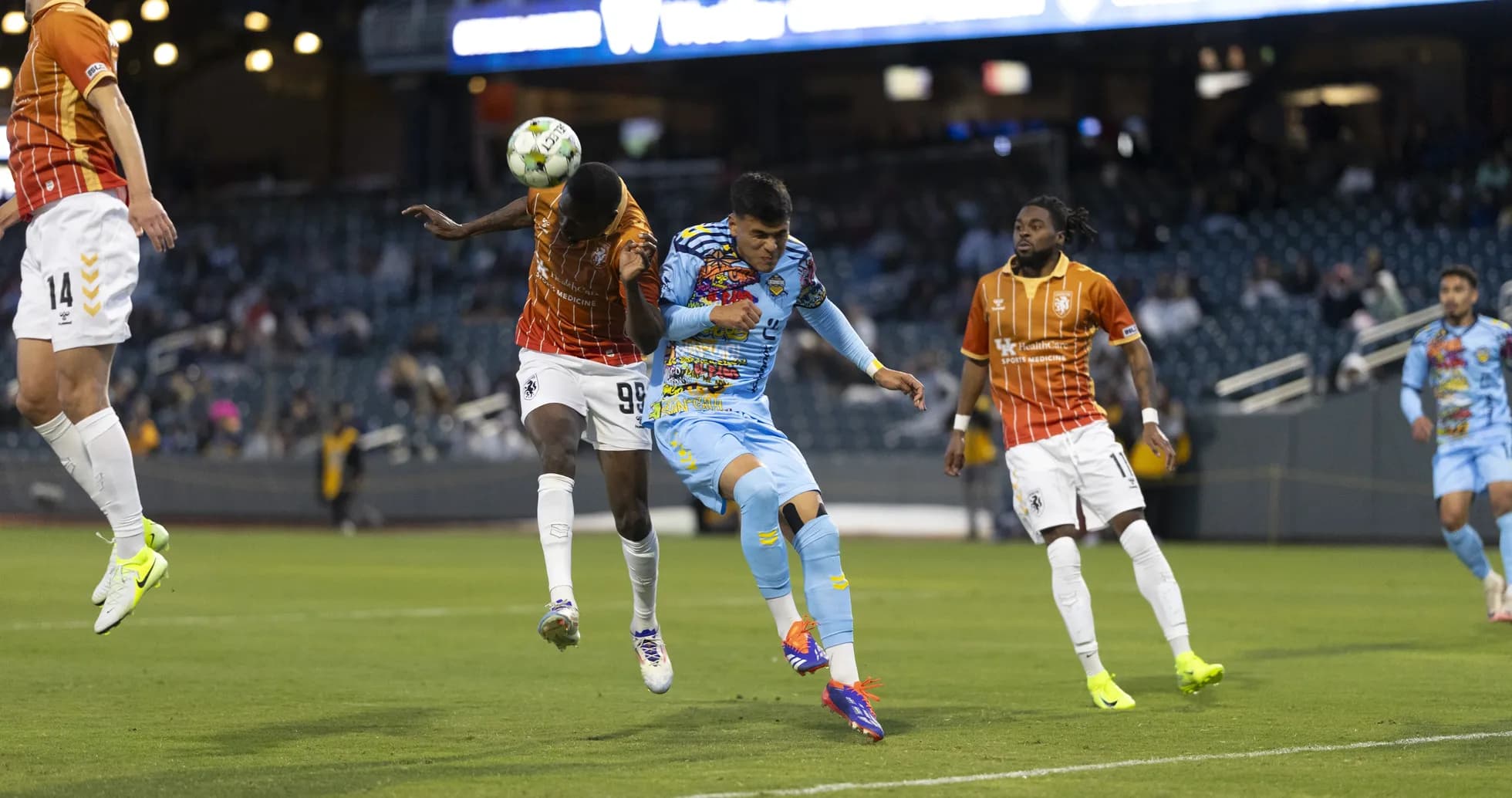 Players competing for the ball in USL Championship match Players competing for the ball in USL Championship match
