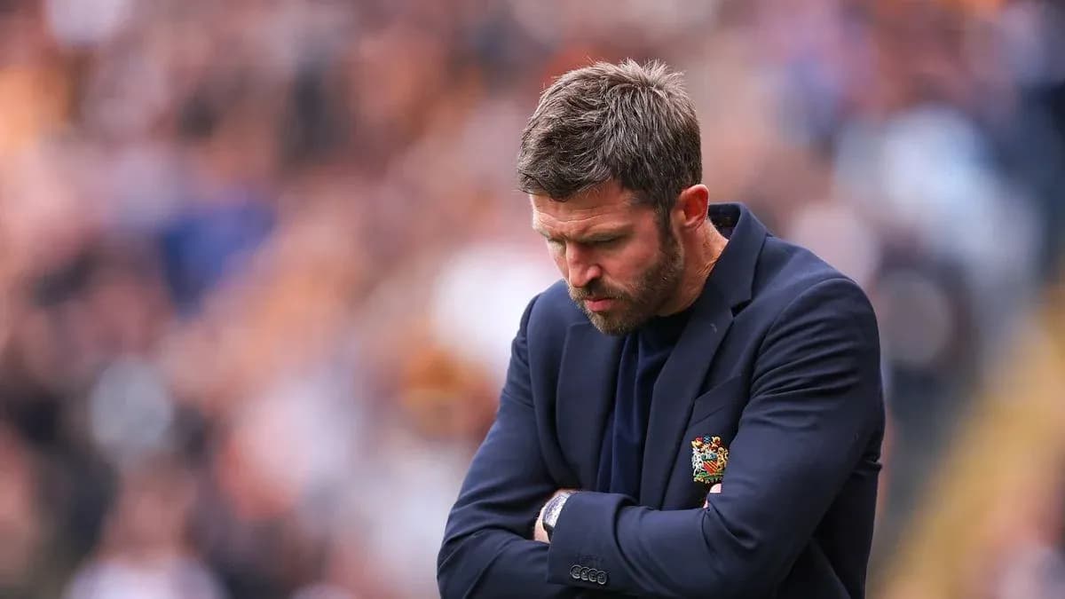 Manager with arms crossed looking down on sideline Manager with arms crossed looking down on sideline