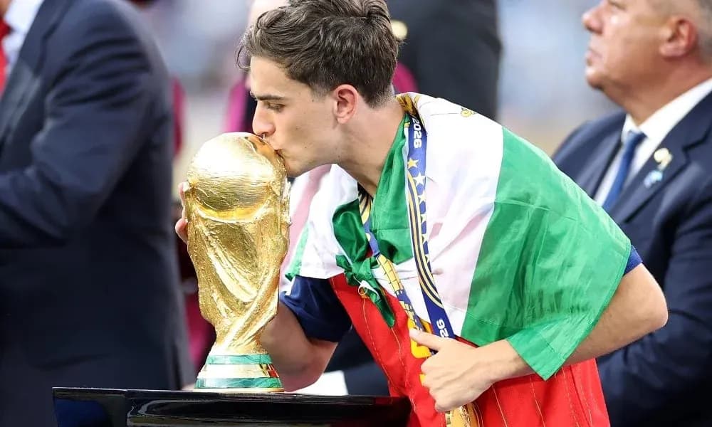 Player kissing the World Cup trophy on stage Player kissing the World Cup trophy on stage