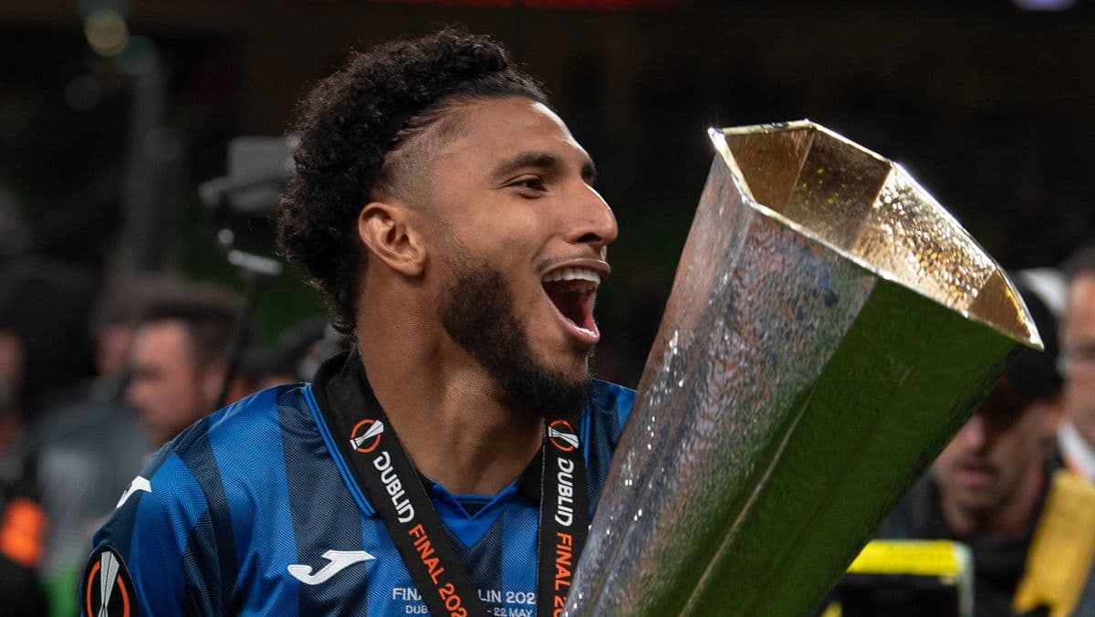 Player celebrating with trophy after match victory Player celebrating with trophy after match victory