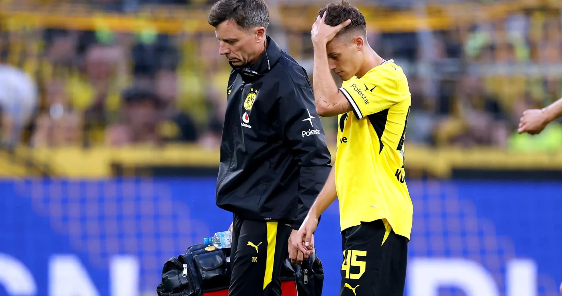 Player receiving medical attention leaving the field Player receiving medical attention leaving the field