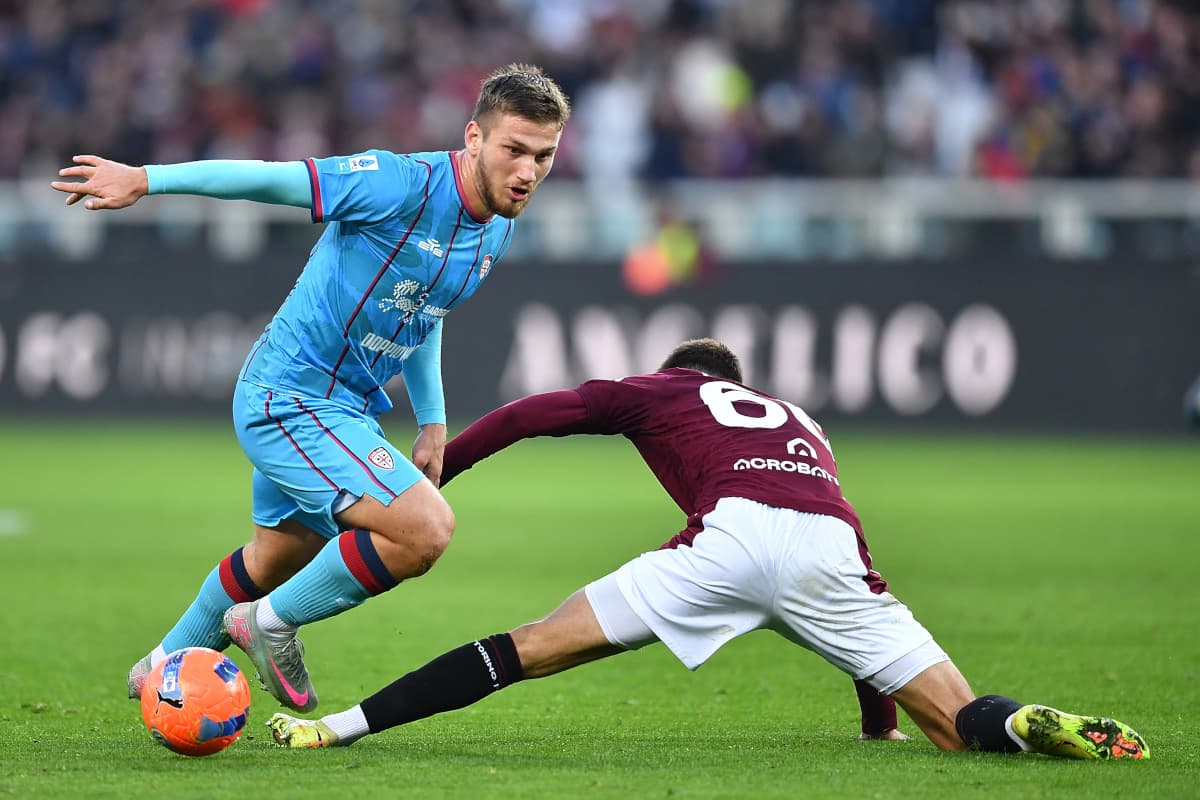 Cagliari player dribbling past Torino defender Cagliari player dribbling past Torino defender