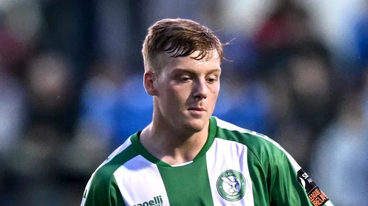 Player wearing green and white jersey during match Player wearing green and white jersey during match