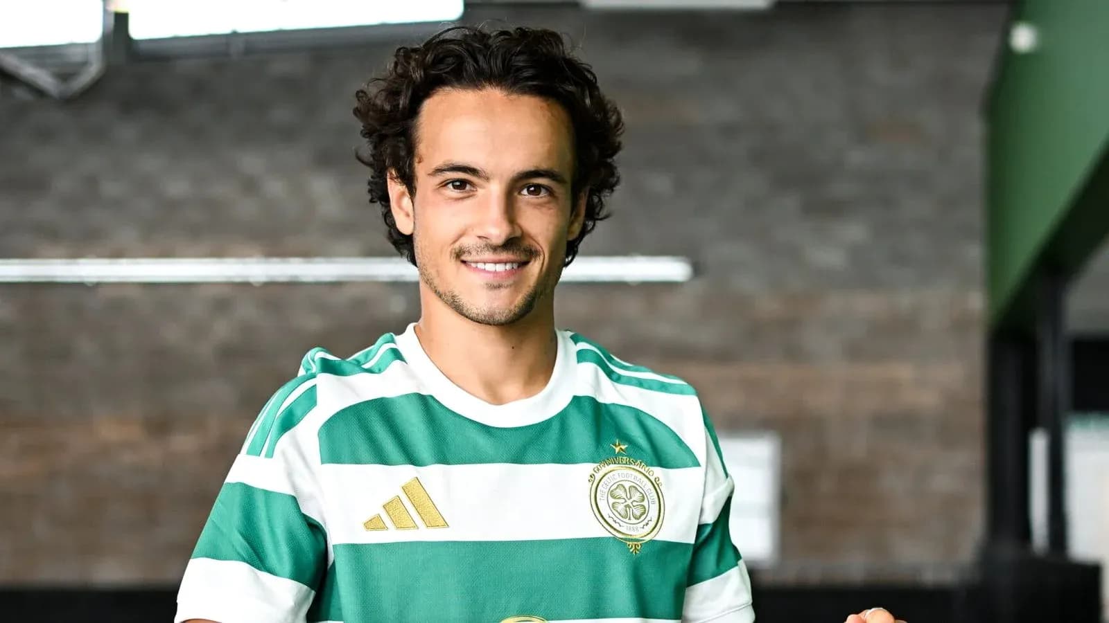 Player wearing green and white striped jersey smiling Player wearing green and white striped jersey smiling
