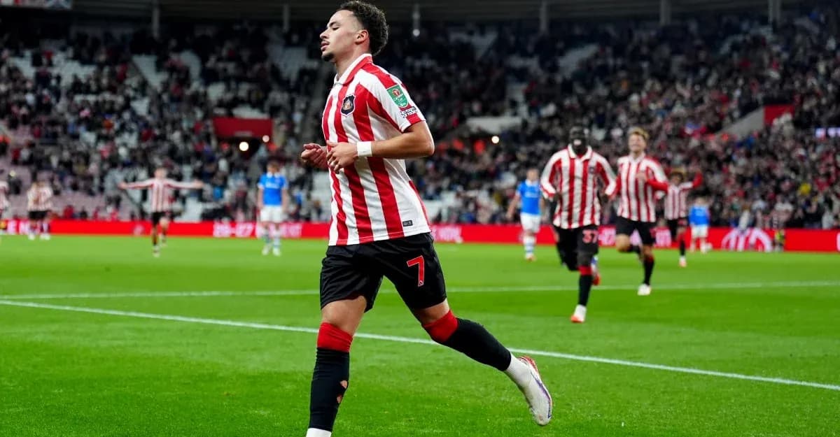 Player celebrating a goal on the pitch Player celebrating a goal on the pitch