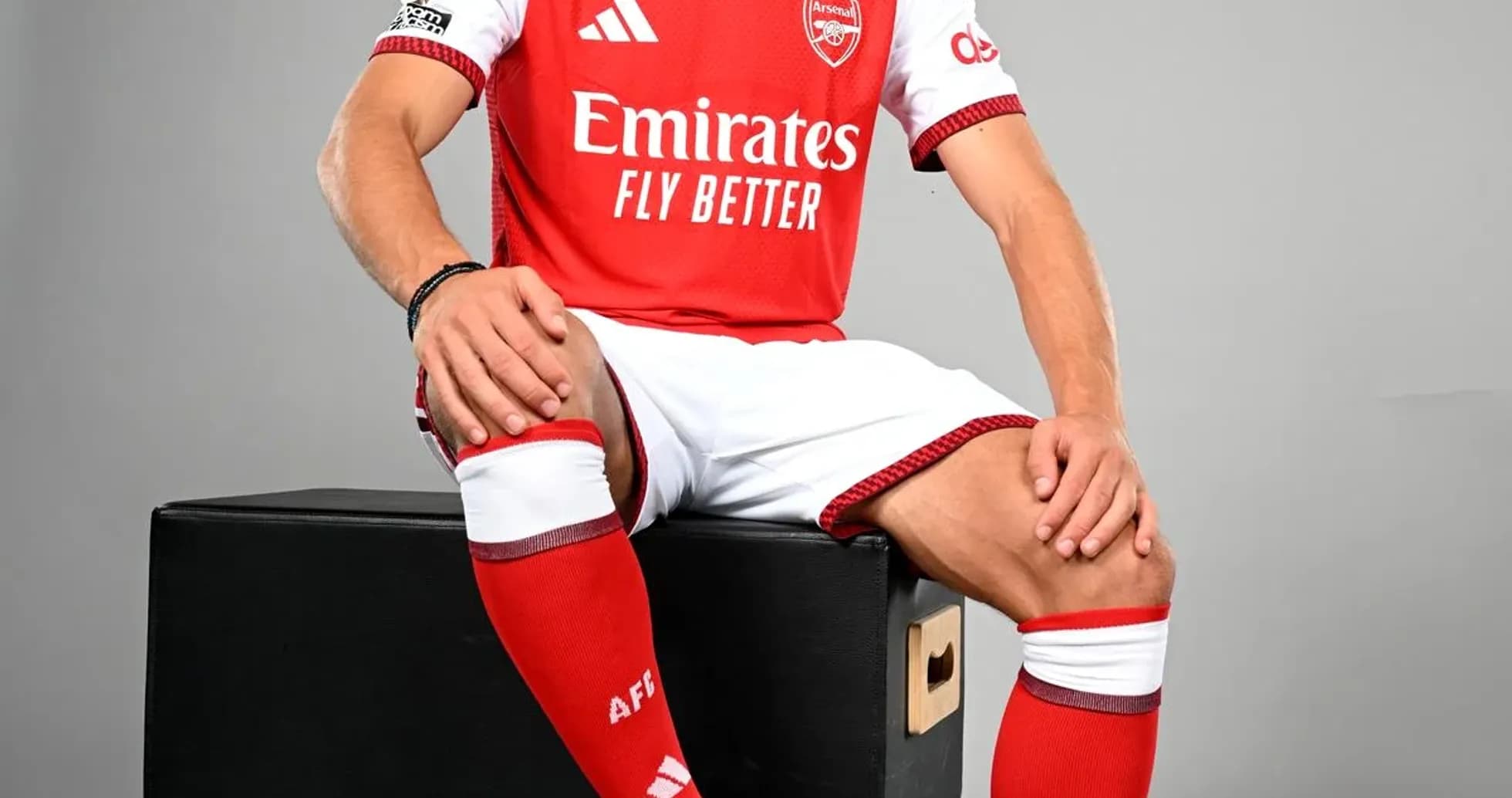 Player in Arsenal kit posing with football Player in Arsenal kit posing with football