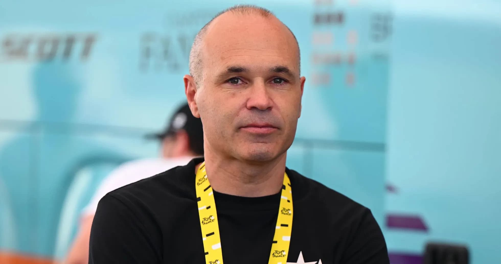 Man wearing a black shirt and yellow lanyard Man wearing a black shirt and yellow lanyard