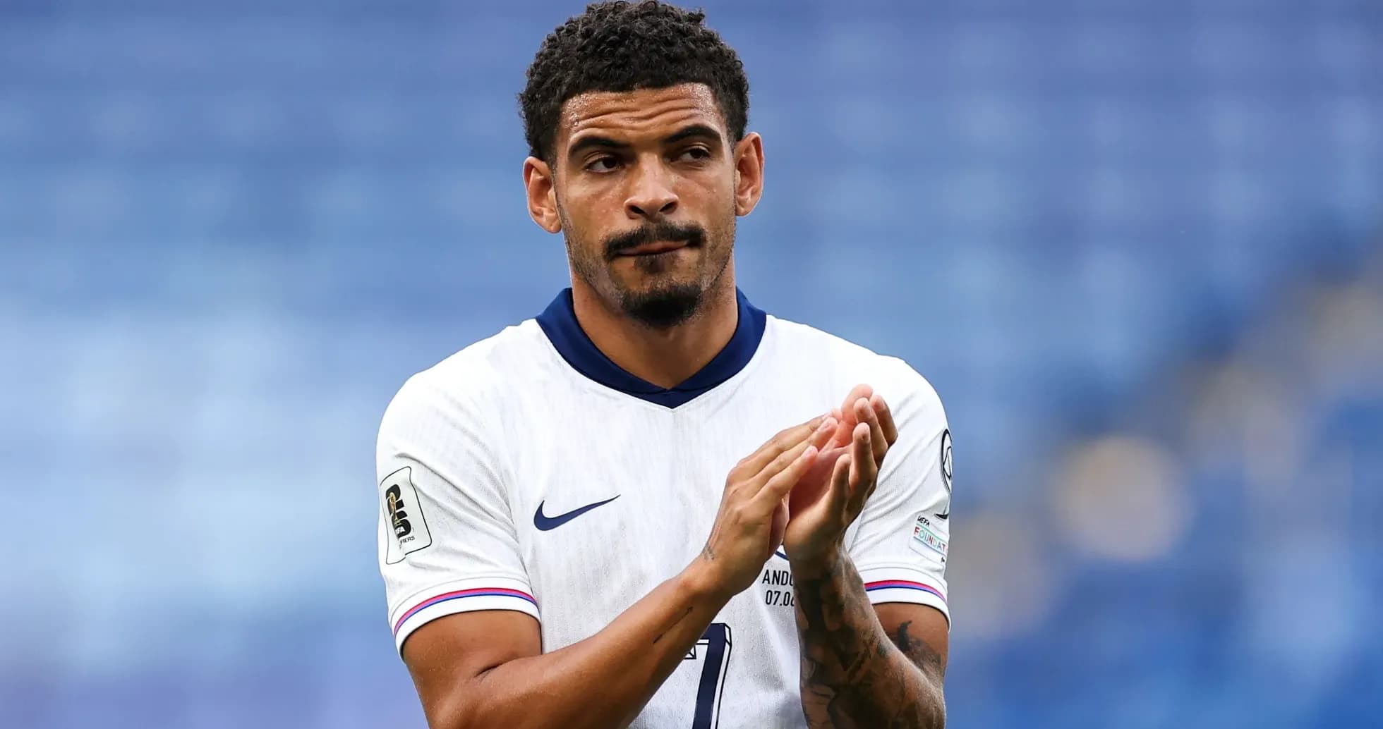 Player applauding in white jersey during match Player applauding in white jersey during match