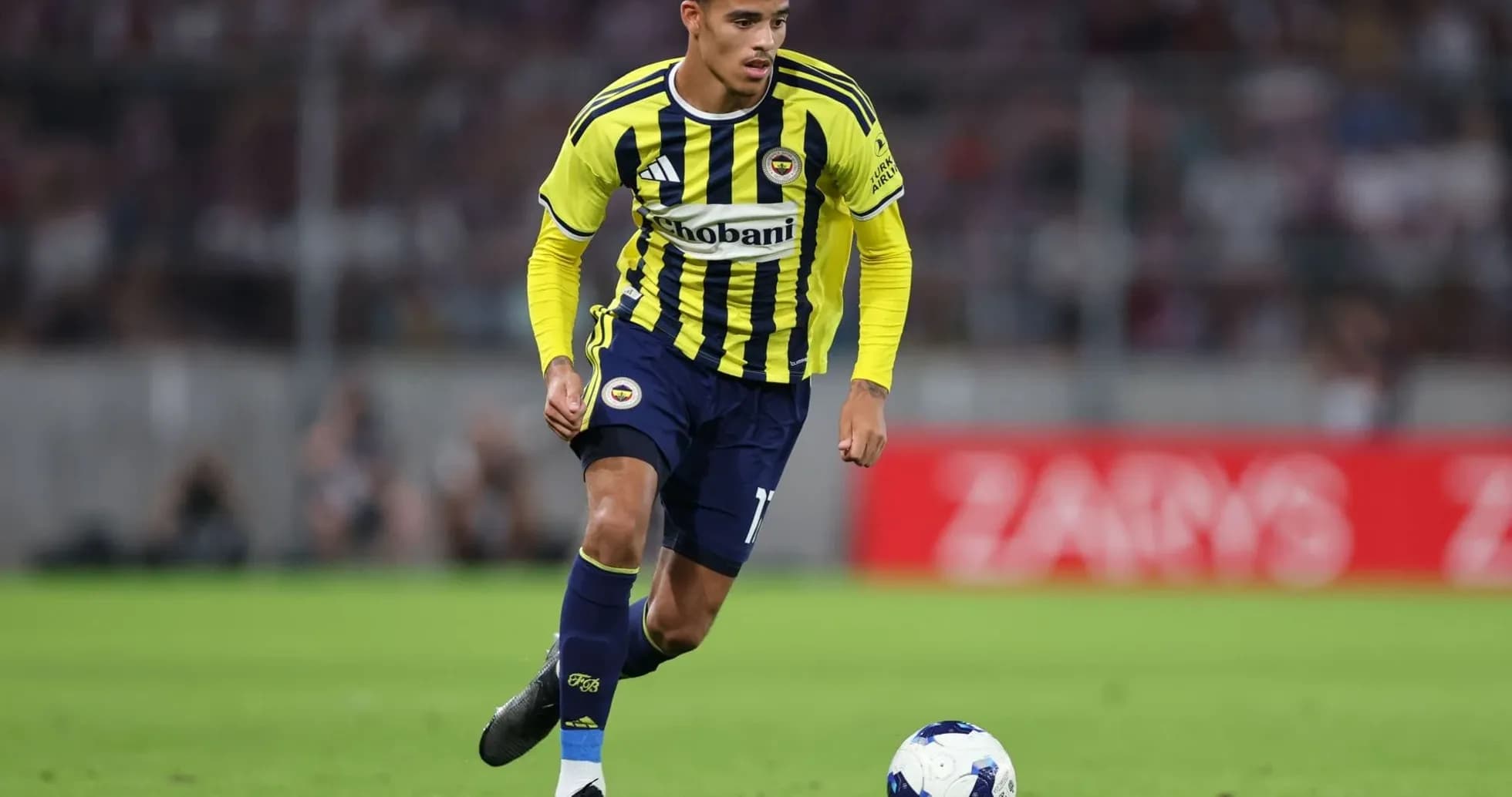 Fenerbahçe player dribbling ball on field Fenerbahçe player dribbling ball on field