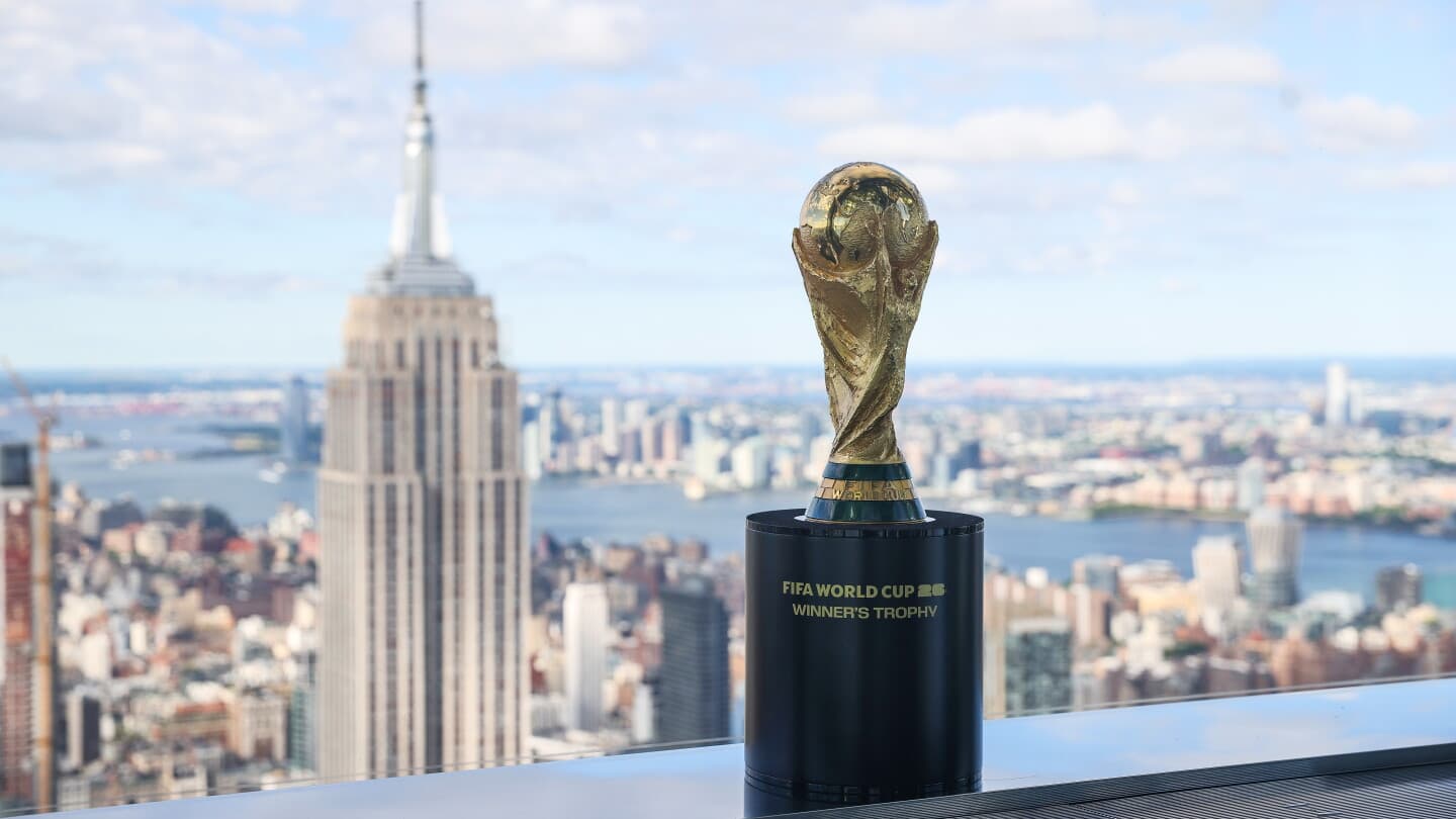 FIFA World Cup trophy with city skyline background FIFA World Cup trophy with city skyline background