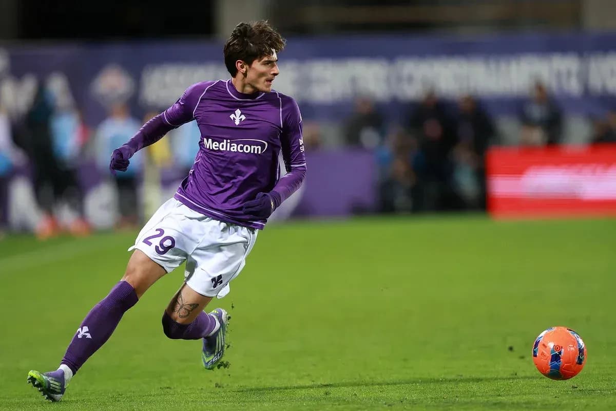Player in purple jersey sprinting after the ball Player in purple jersey sprinting after the ball