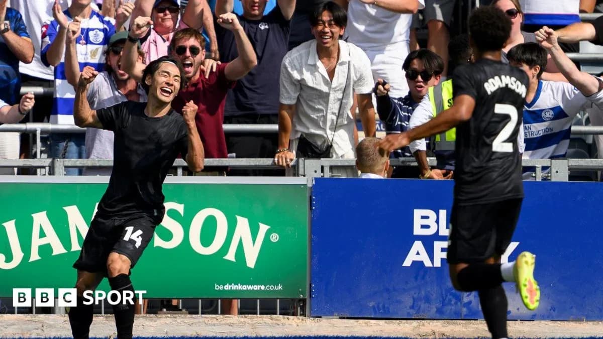 Player celebrating a goal with fans in background Player celebrating a goal with fans in background