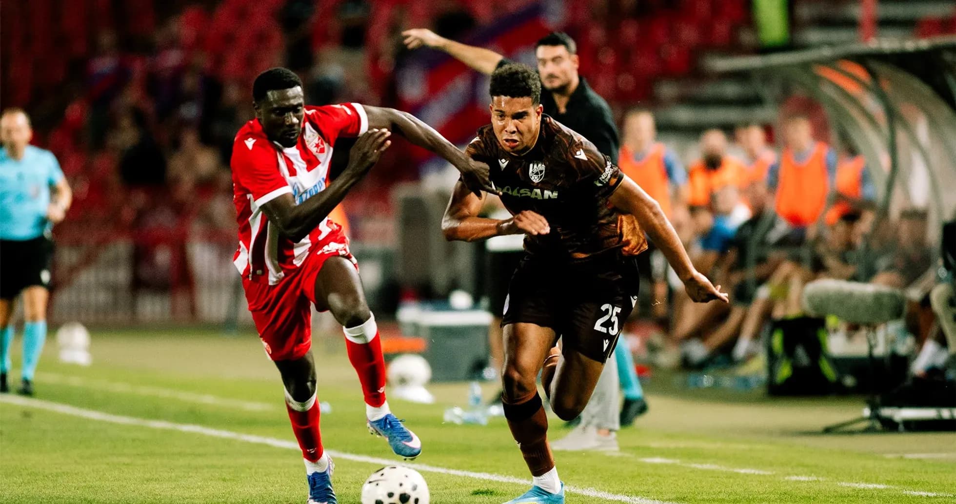 Players competing for the ball in UEFA match Players competing for the ball in UEFA match