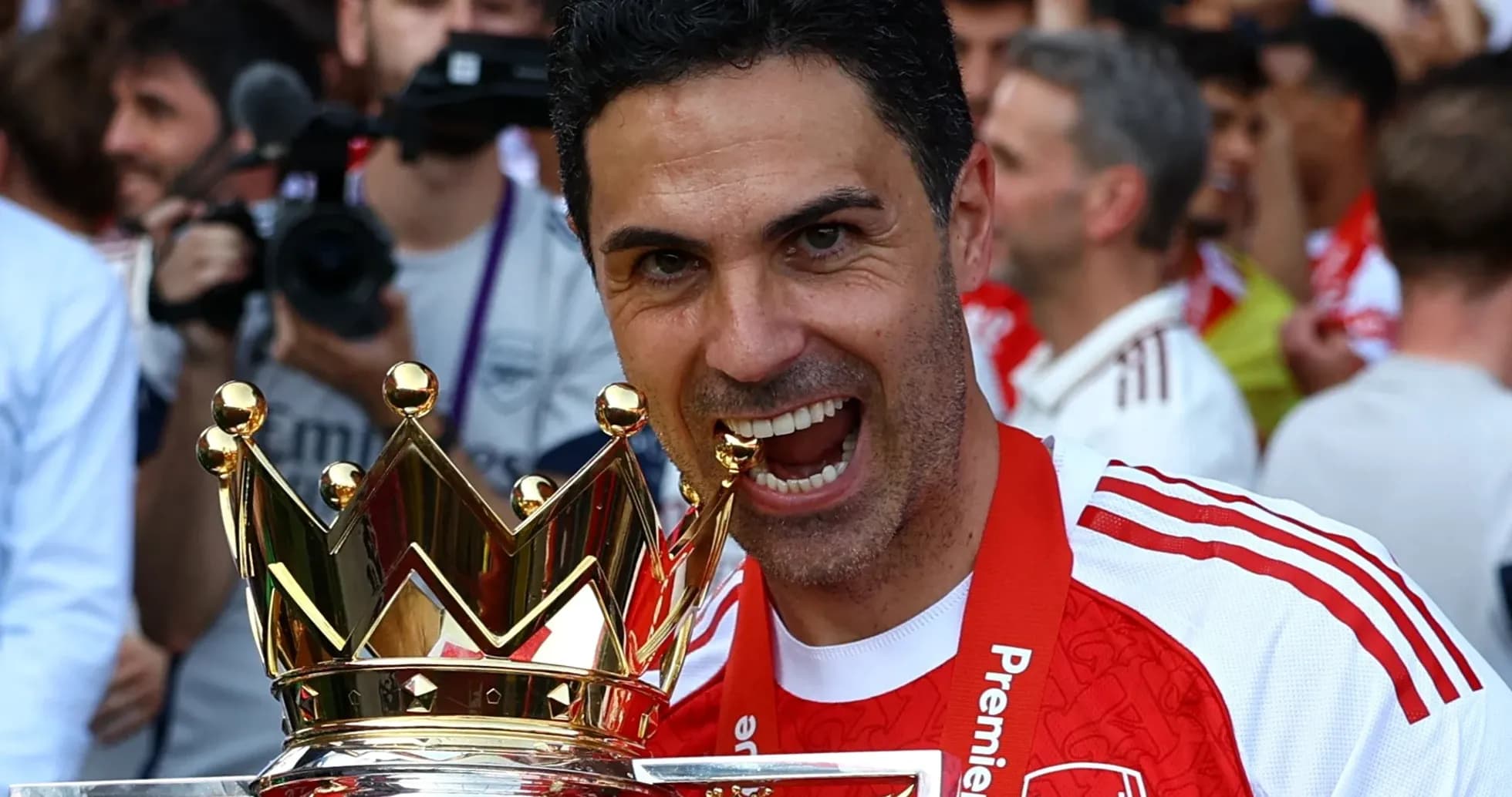 Manager celebrating with Premier League trophy Manager celebrating with Premier League trophy