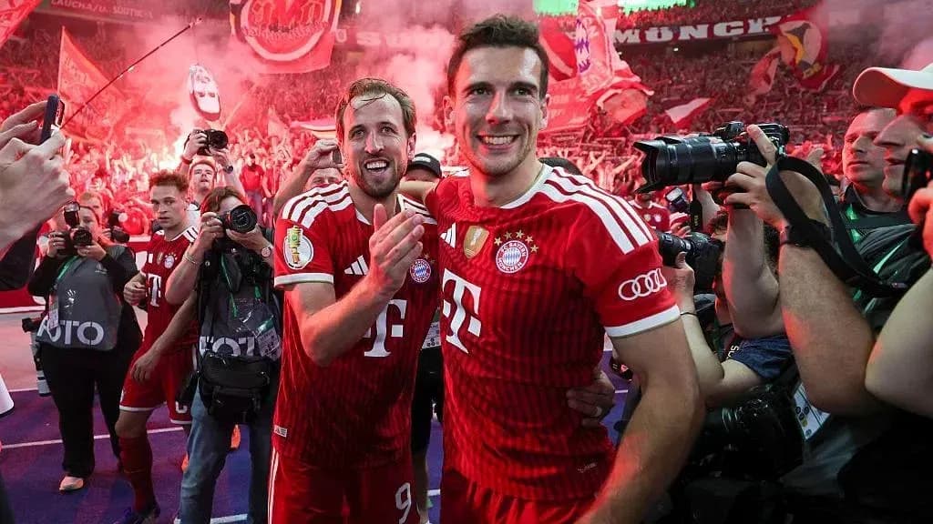 Bayern Munich players celebrating with fans in stadium Bayern Munich players celebrating with fans in stadium