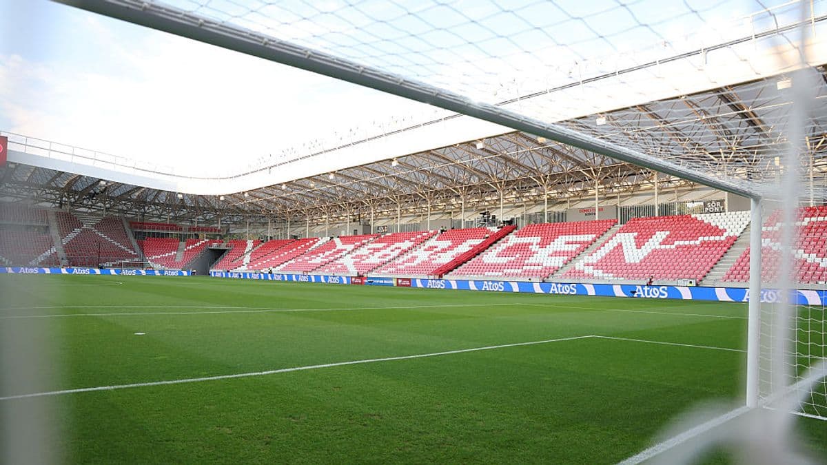 View of a football pitch inside a stadium View of a football pitch inside a stadium