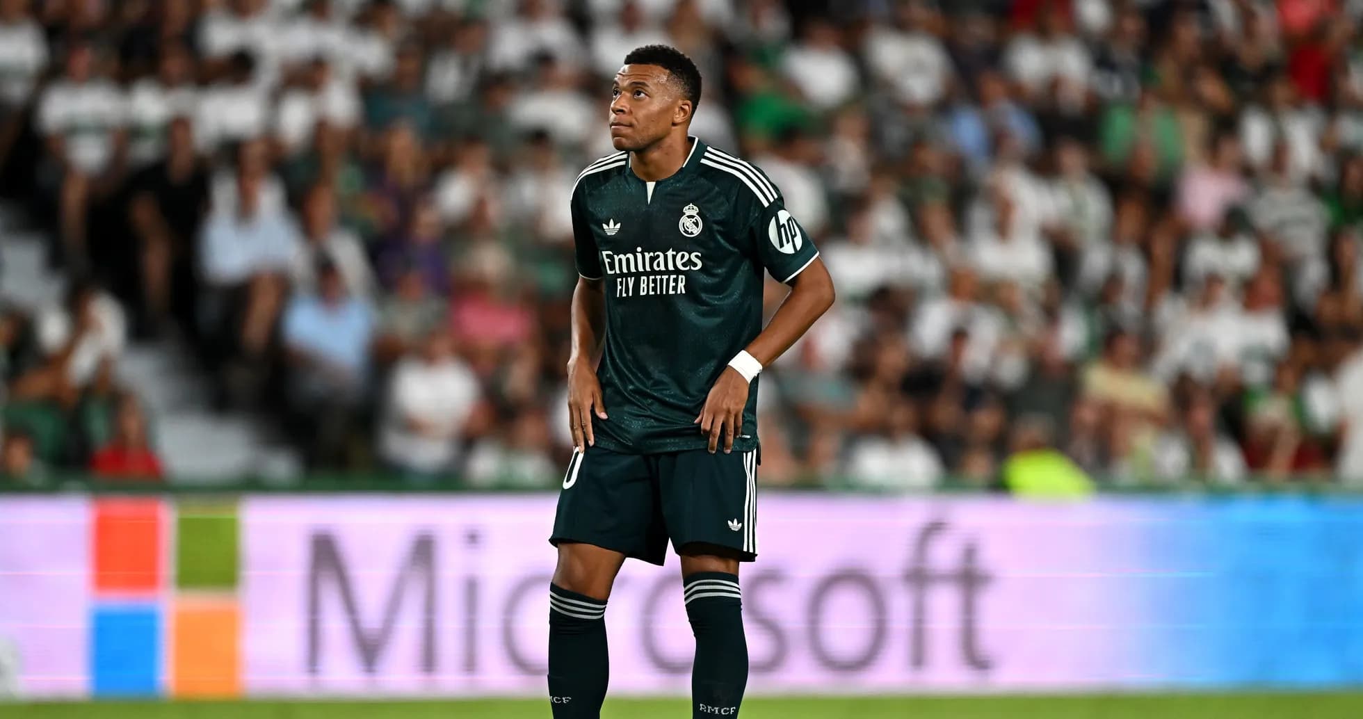 Player in dark green jersey on the field Player in dark green jersey on the field
