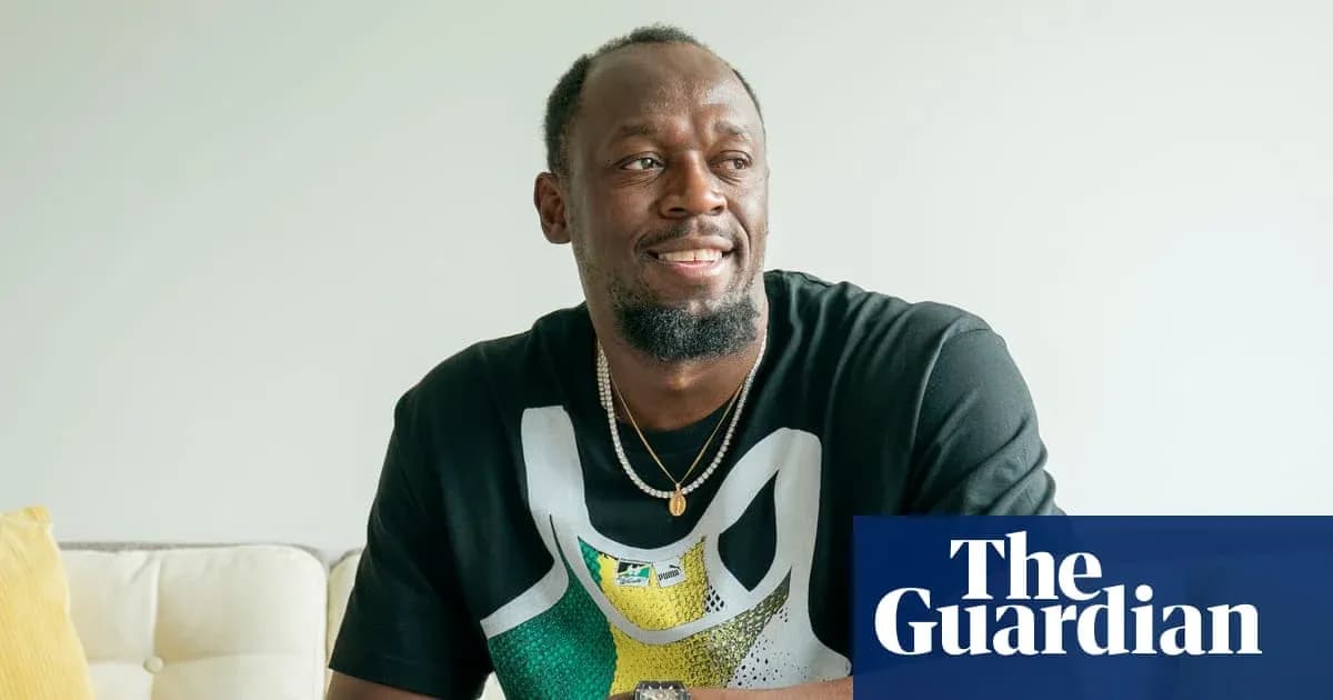 Athlete smiling while sitting on a couch Athlete smiling while sitting on a couch