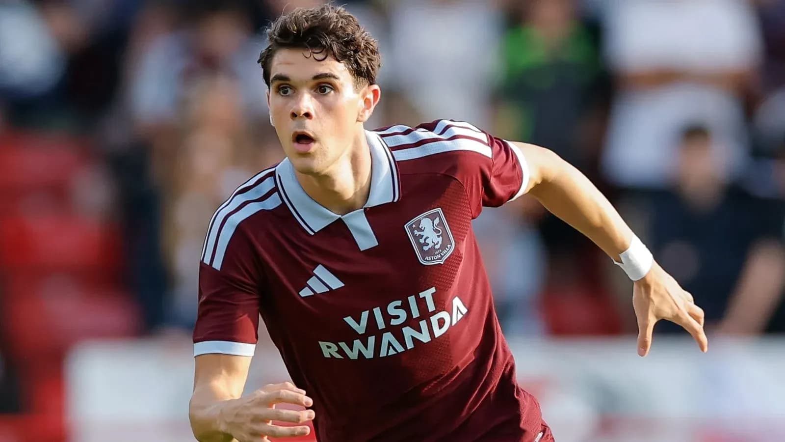 Player sprinting in Aston Villa kit during match Player sprinting in Aston Villa kit during match