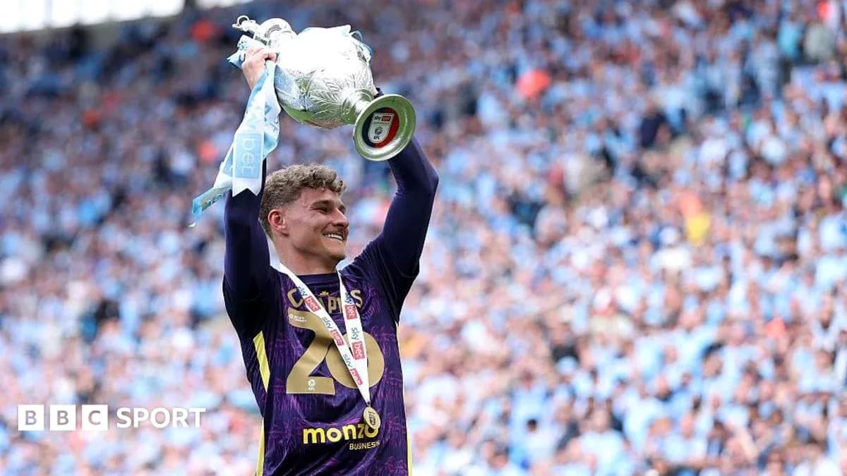 Player celebrating with trophy in stadium Player celebrating with trophy in stadium