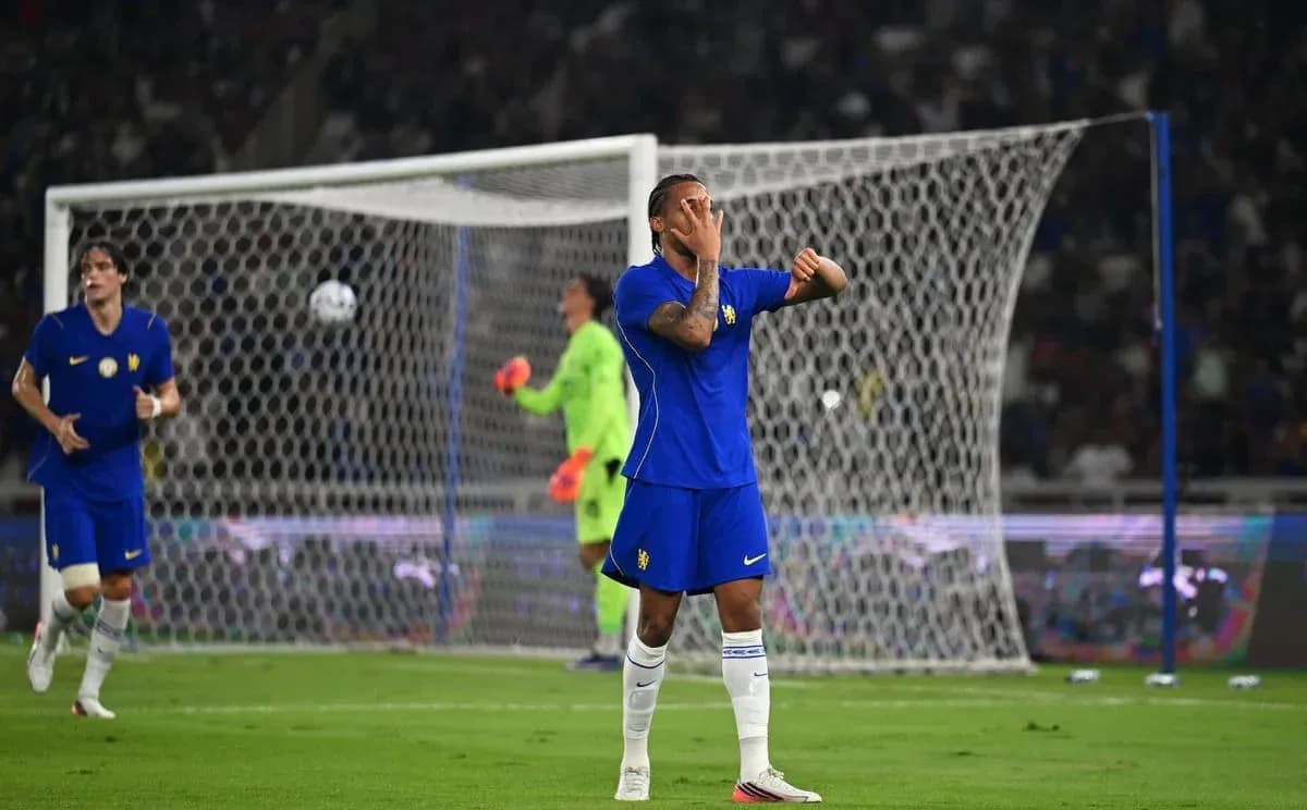 Player reacting during match with goal in background Player reacting during match with goal in background