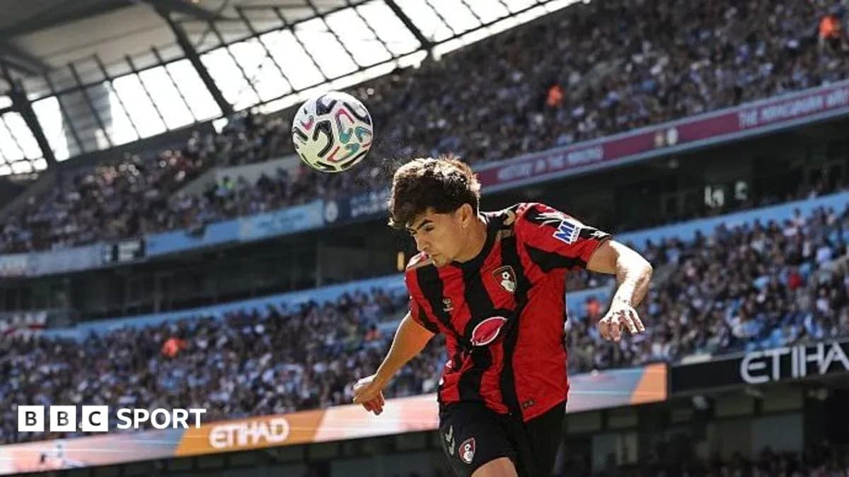 Bournemouth player heading ball during match at Etihad Stadium Bournemouth player heading ball during match at Etihad Stadium