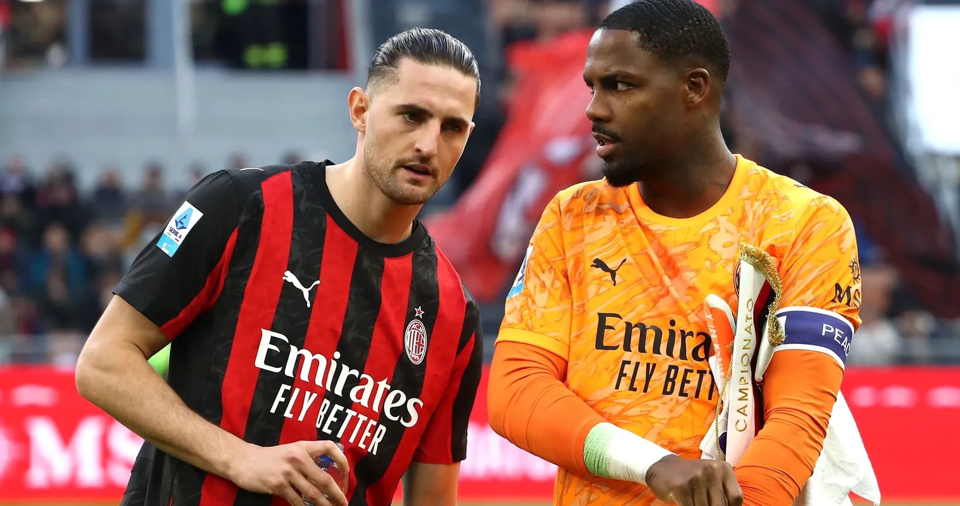 Two AC Milan players discussing on the field Two AC Milan players discussing on the field