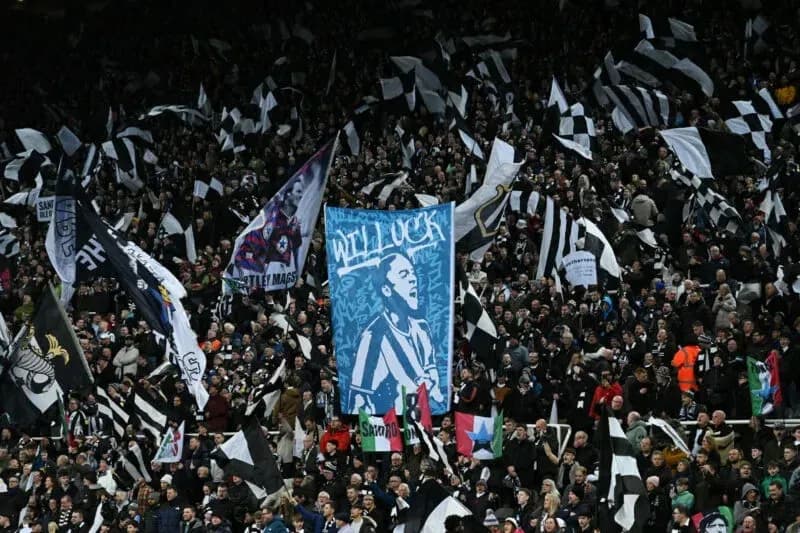 Crowd waving black and white flags at stadium Crowd waving black and white flags at stadium