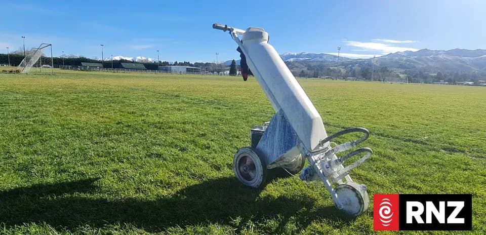 Line marking machine on a soccer field Line marking machine on a soccer field