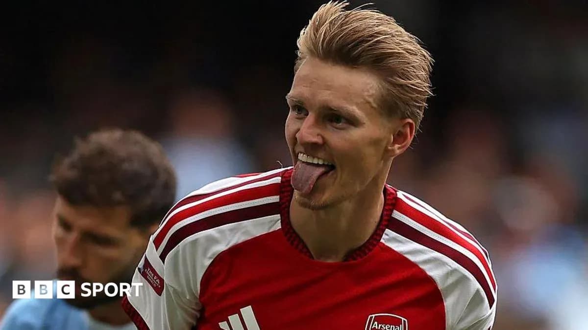 Player celebrating with tongue out in Arsenal jersey Player celebrating with tongue out in Arsenal jersey
