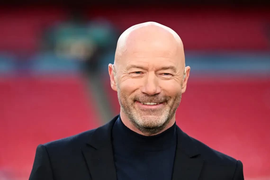 Man smiling in a suit at stadium Man smiling in a suit at stadium