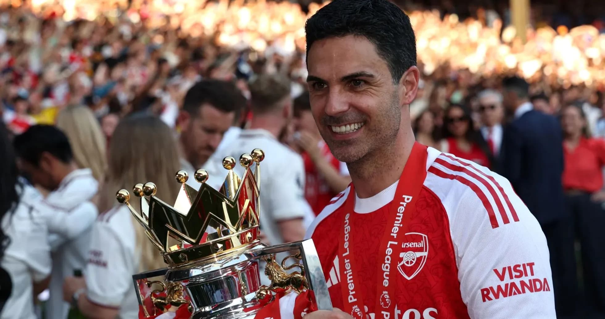 Manager holding Premier League trophy in celebration Manager holding Premier League trophy in celebration