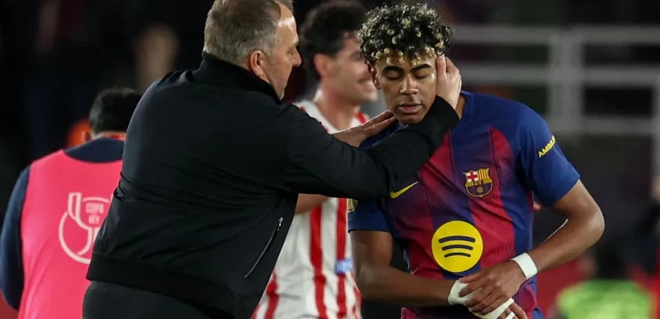 Coach interacting with Barcelona player on field Coach interacting with Barcelona player on field