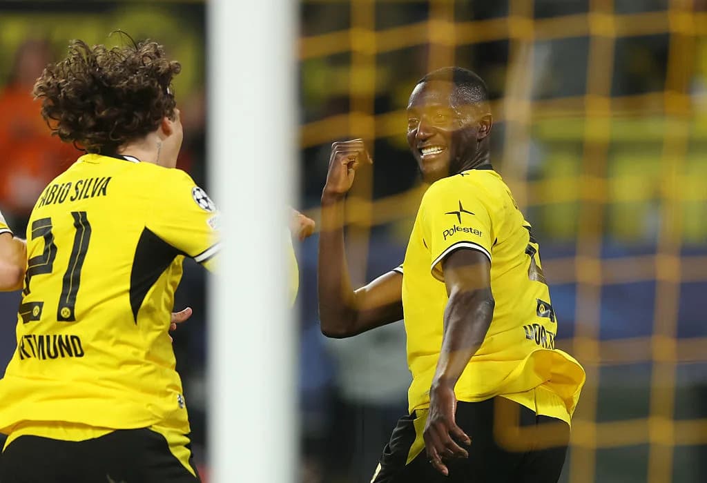 Two Borussia Dortmund players celebrating a goal Two Borussia Dortmund players celebrating a goal