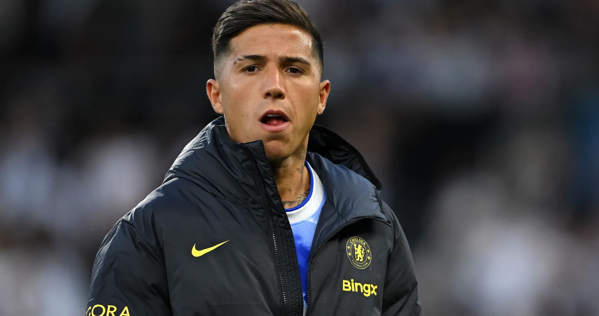 Player wearing Chelsea jacket on the sidelines Player wearing Chelsea jacket on the sidelines