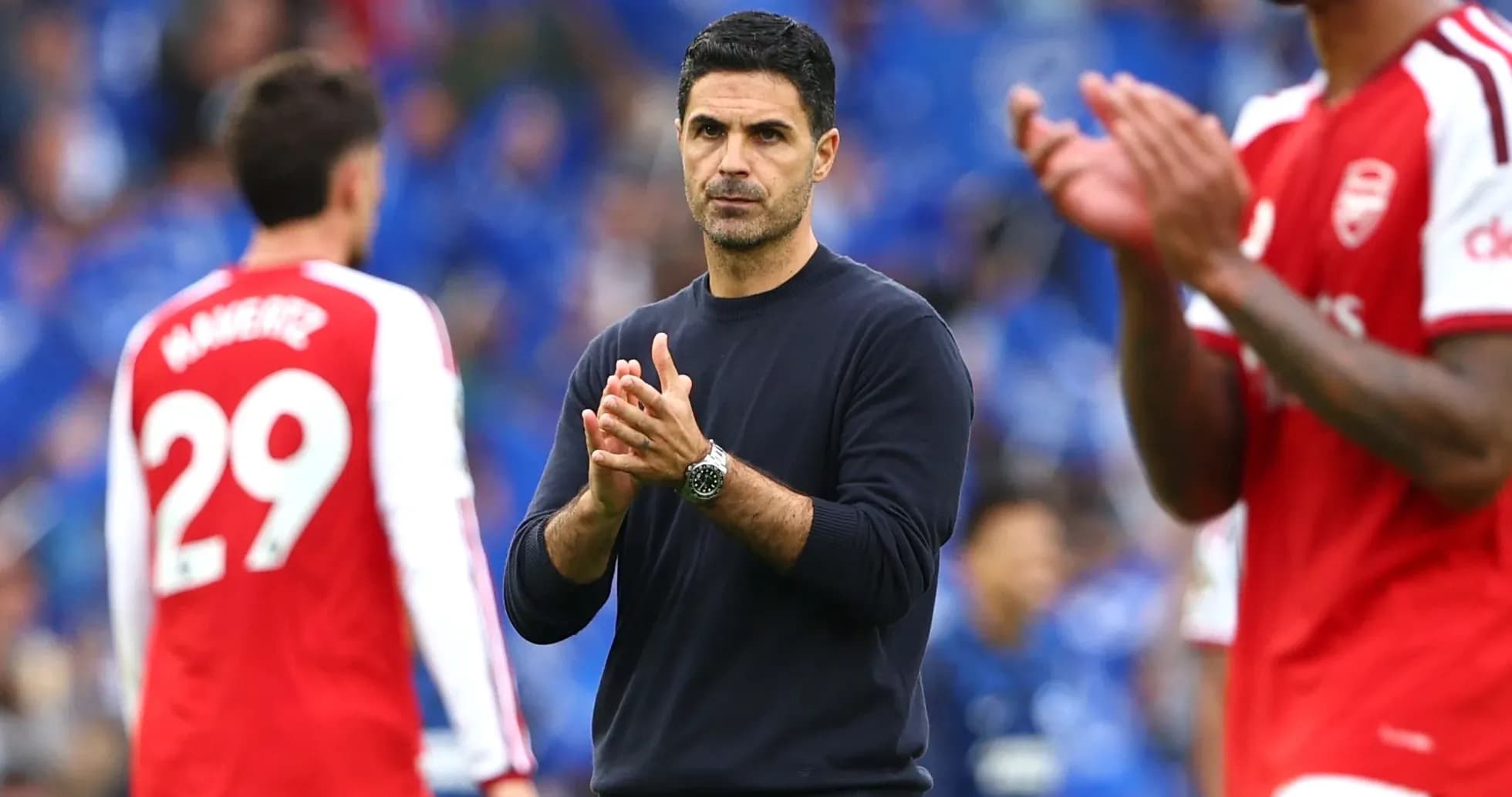 Manager clapping during match with players nearby Manager clapping during match with players nearby